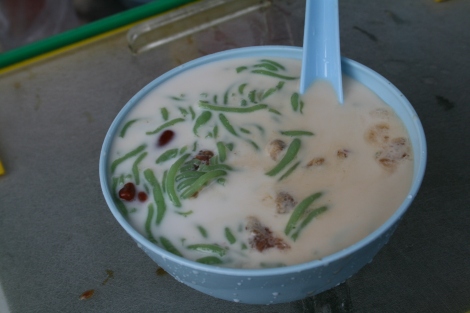 Cendol in a blue plastic bowl with spoon.